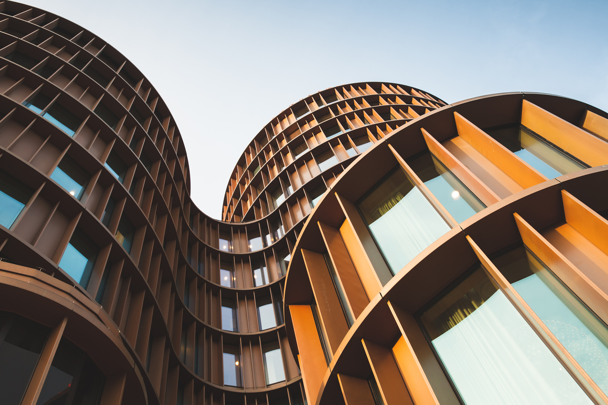 Vertical view of an abstract contemporary building with the sky as background