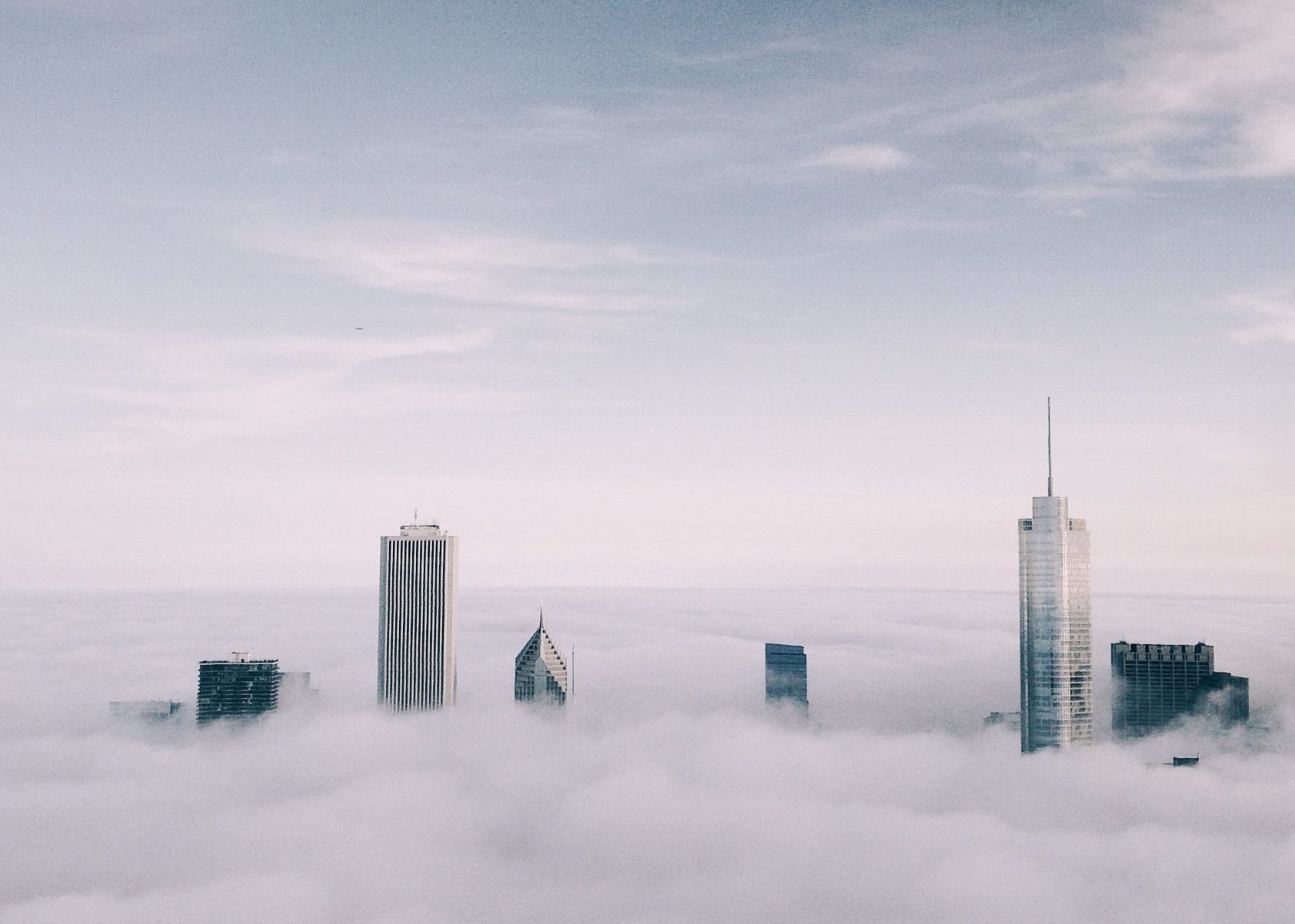 An image of the Chicago skyline with fog and clouds