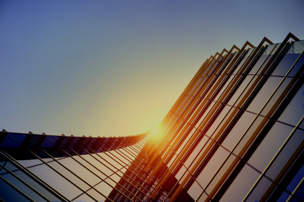 A vertical view of the exterior walls of Bravura Solutions' building and the sunny sky