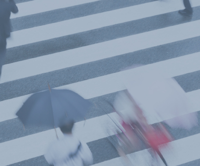 Motion image of people crossing the street on a cloudy day