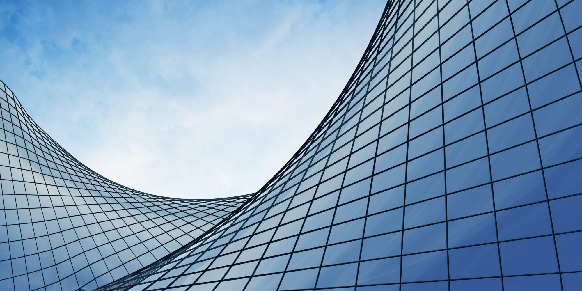 View of the clouds reflected in the curve glass office Bravura building