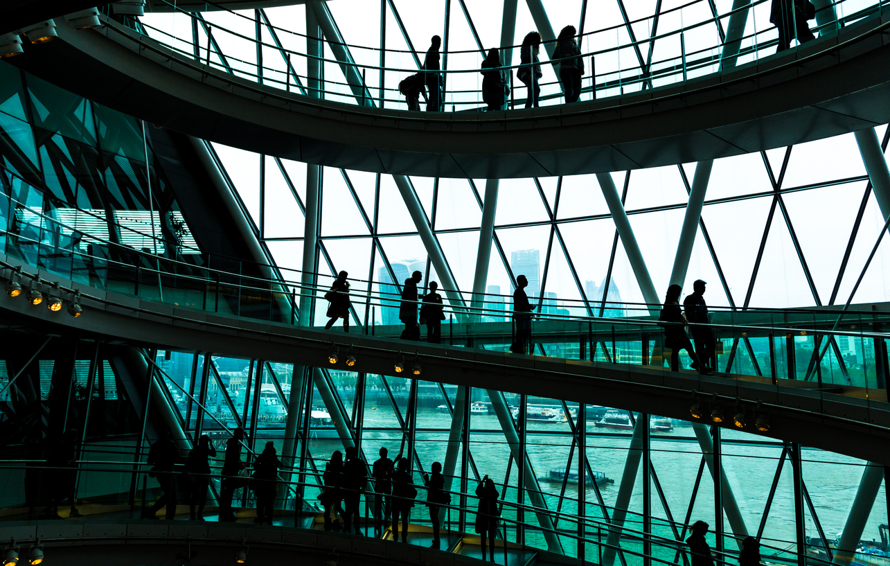 People walking in the innovative interior architecture of a business building in the UK