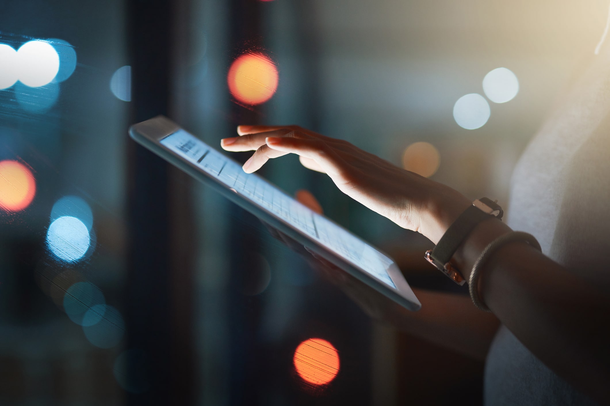 A person is holding a tablet and typing information on a digital solution