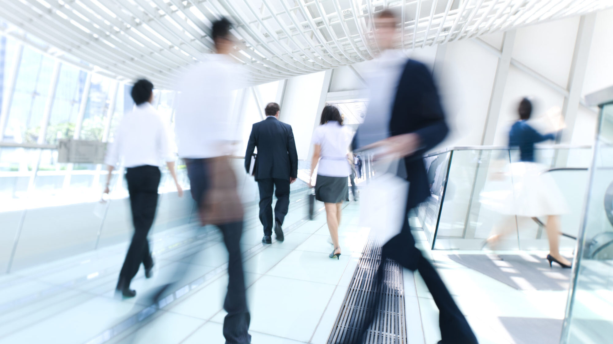 Blurred photo of business people in a rush at work