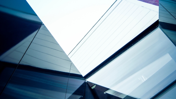 Abstract view of modern glass and steel architecture with sharp angles and reflections – featured image for Garradin Bravura technology