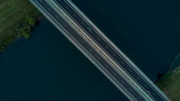 Top-down view of highway bridge crossing dark water at dusk – featured image for ePASS Bravura technology