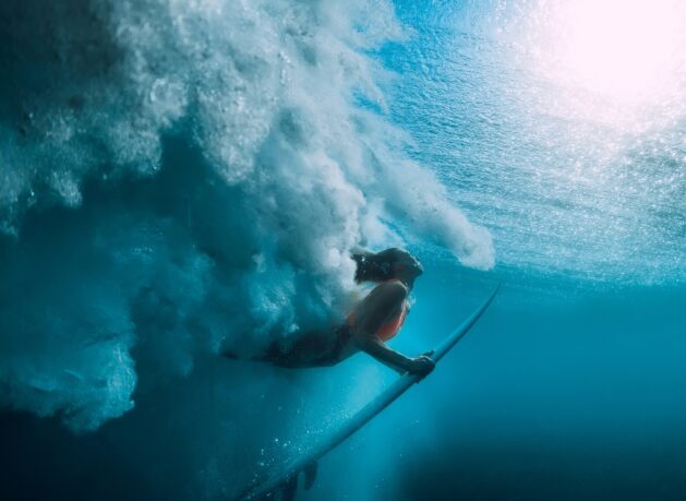 Surfer riding a wave underwater, representing challenge, confidence, and opportunity when you work with us at Bravura - hero image